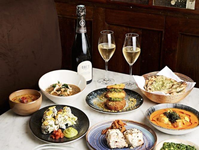 A fantastic spread of curries and Indian food with two glasses of fizz at Trishna restaurant