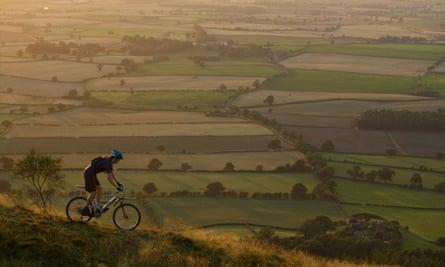 Mountain biker riding down a hill.Shropshire, UK